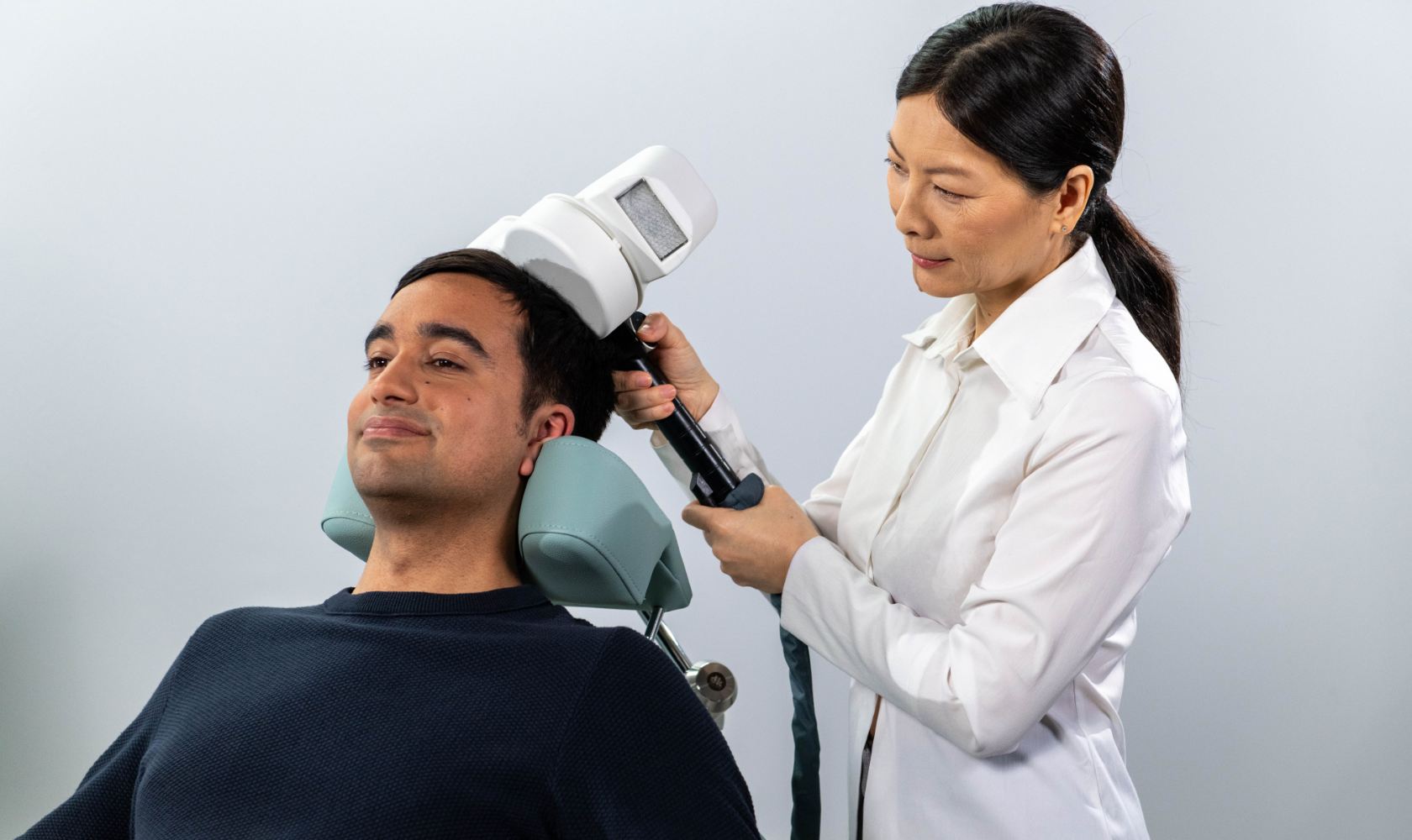 neurocare-clinician-places-tms-coil-on-patients-head